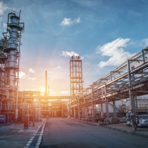 Pipeline and pipe rack of petroleum industrial plant with sunset sky background